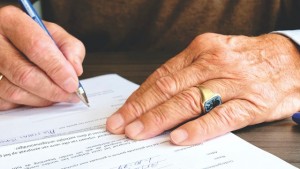 old person signing a will